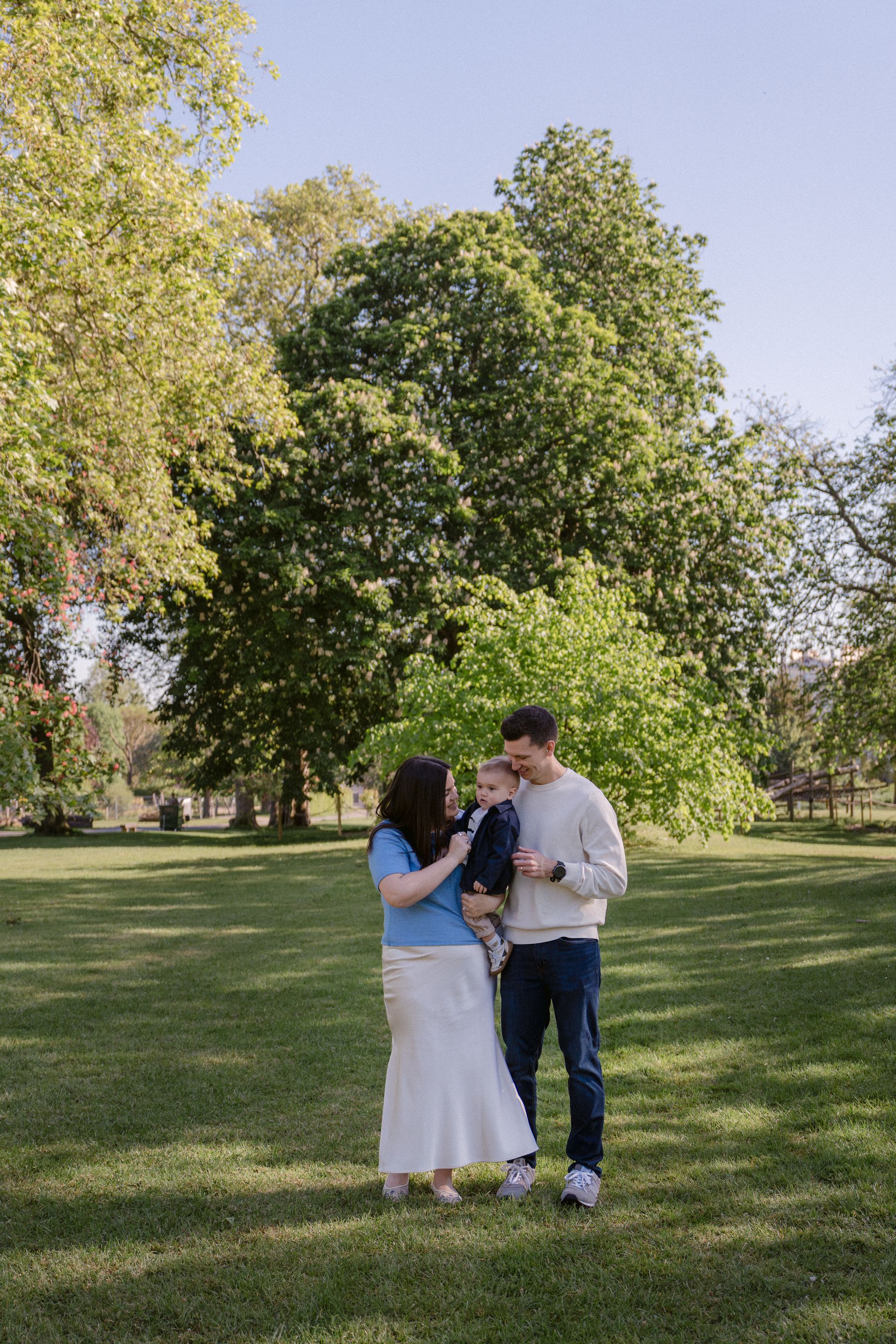 A mother, father and toddler during a family session in Regent's Park, London