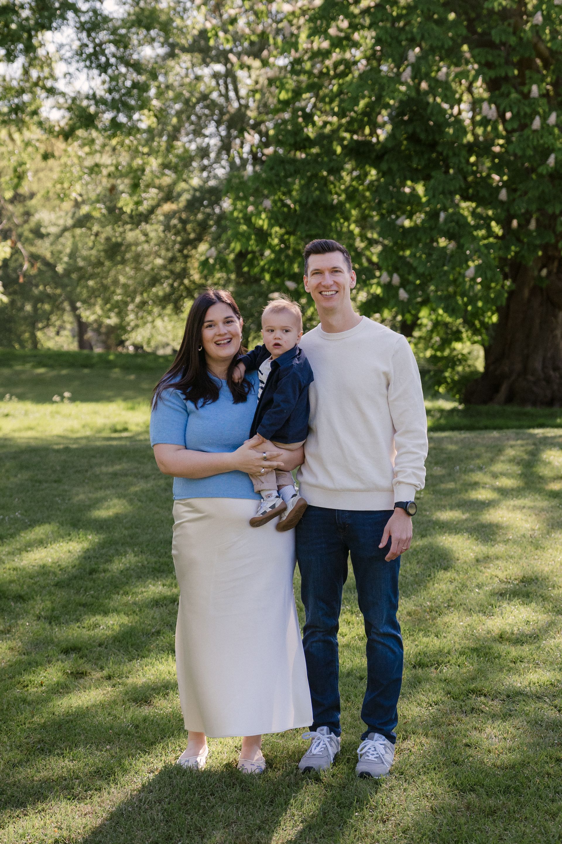 A mother, father and child during a family session in Regent's Park, London