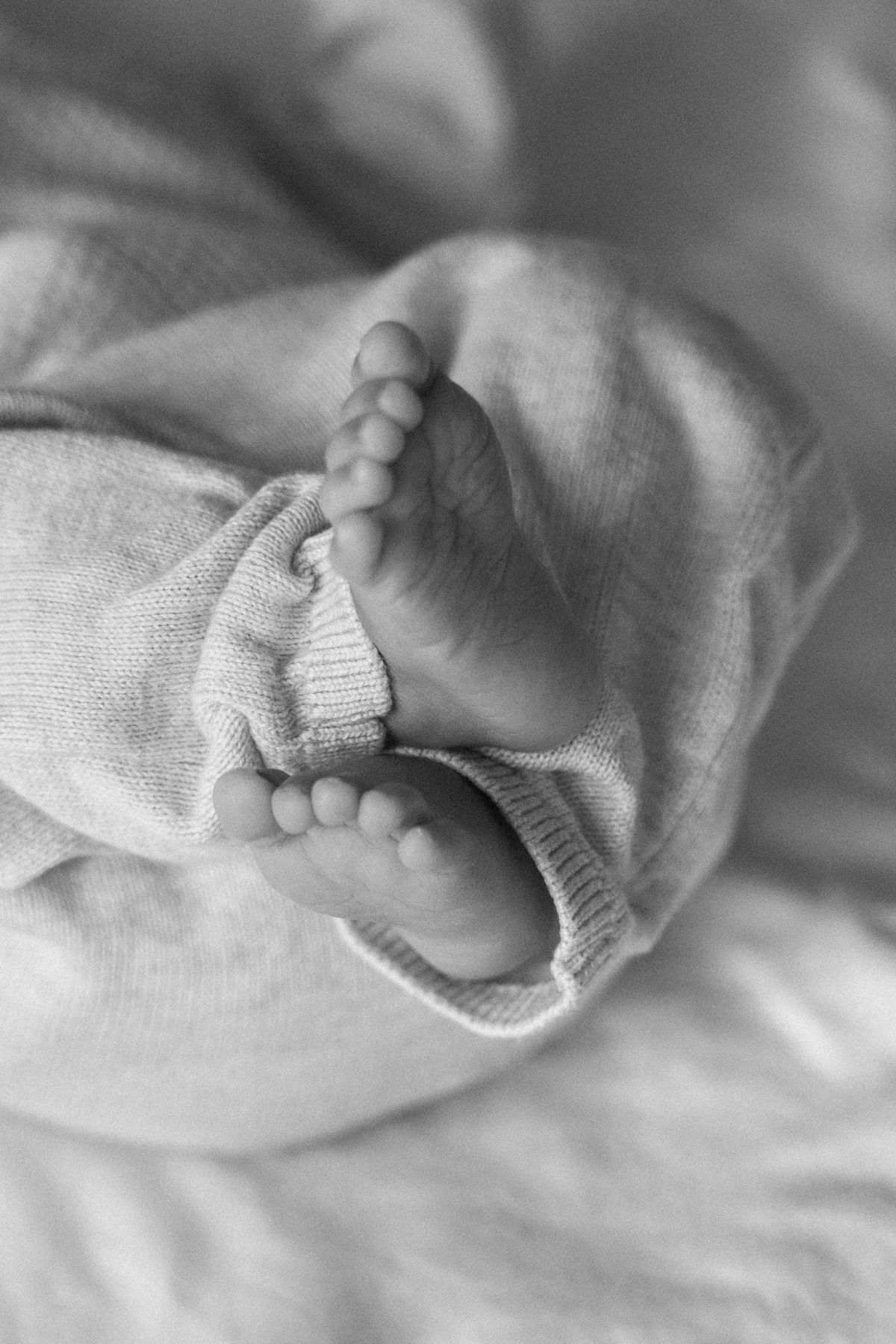 Close-up of a newborn baby's feet at a London newborn session, in black and white